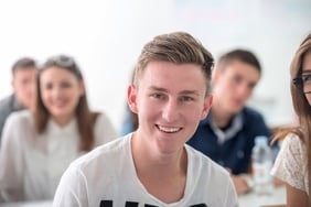 Portrait of a smiling teenage student in classroom